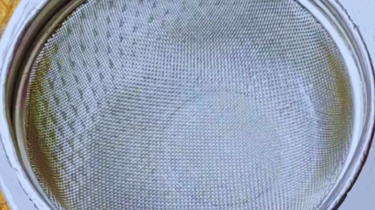 A strainer over a bowl