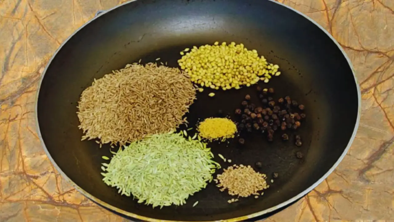 Adding 4 tbsp of cumin seeds, 3 tbsp of fennel seeds, 2 tbsp of coriander seeds, 1 tbsp black pepper, ½ tsp of carom seeds, and ¼ tsp asafetida in it one by one