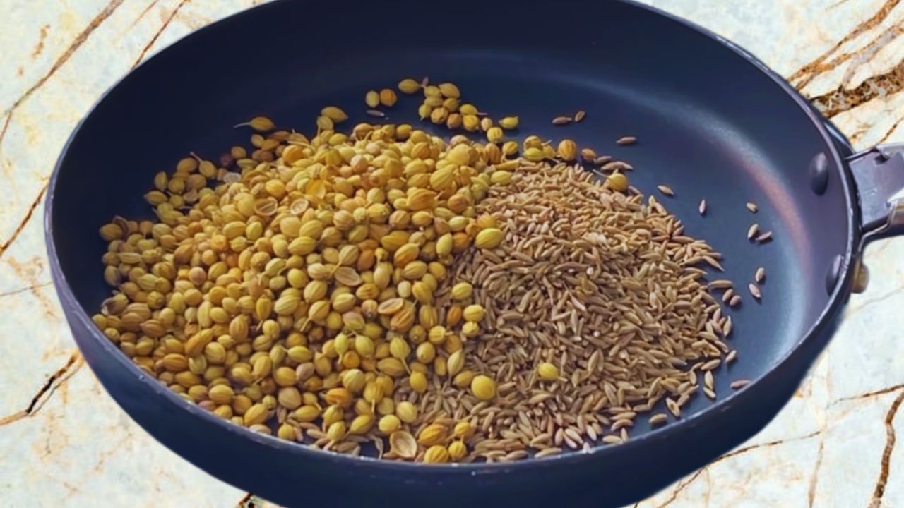Adding 3 tbsp of cumin seeds and 3 tbsp of coriander seeds in a frying pan