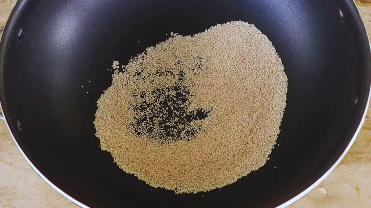 Putting 20 gms of poppy seeds (khus khus) into the wok