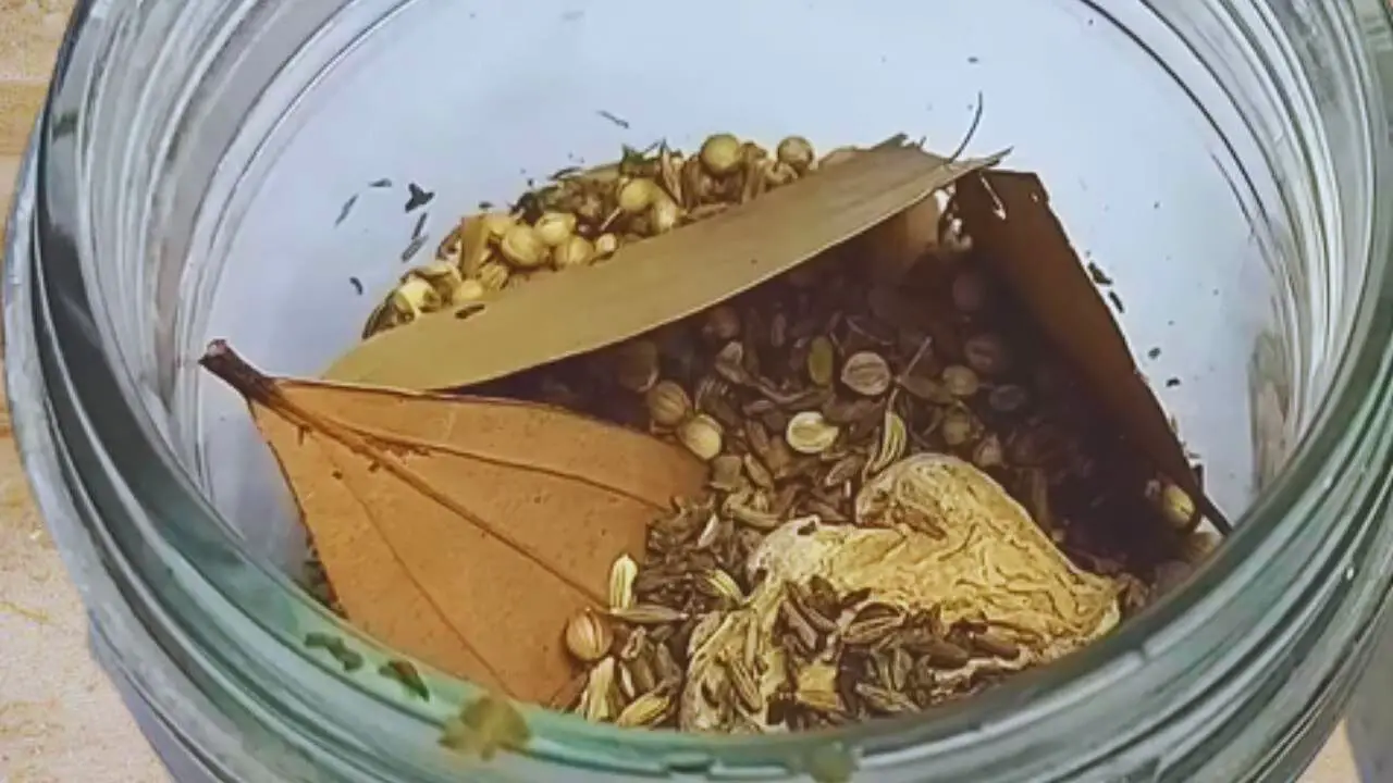 Transferring the roasted spices into the grinder