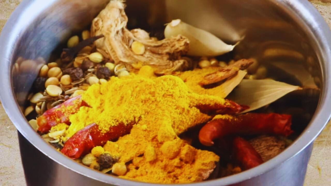 Adding ½ tbsp of turmeric powder to the ingredients in grinder