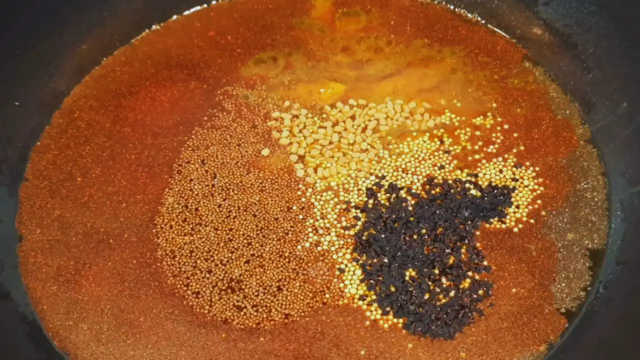 Added 1 tbsp Kashmiri red chili powder, 1 tbsp red chili powder, 1 tbsp salt, 1 tbsp turmeric powder, 1 tbsp brown mustard seeds, 1 tbsp yellow mustard seeds, ½ tbsp fenugreek seeds and ½ nigella seeds