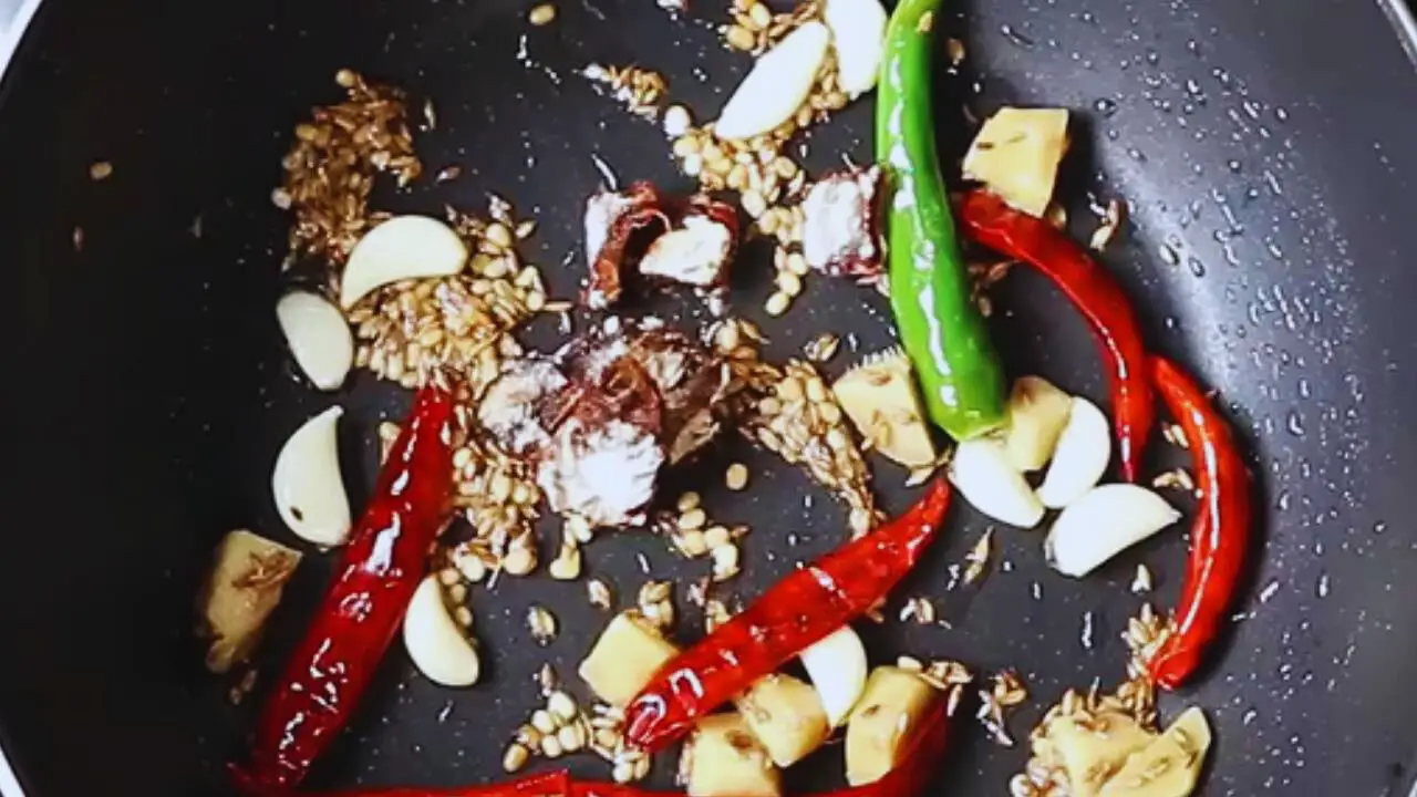 Added a small piece, about the size of a gooseberry, of tamarind to the ingredients in the frying pan