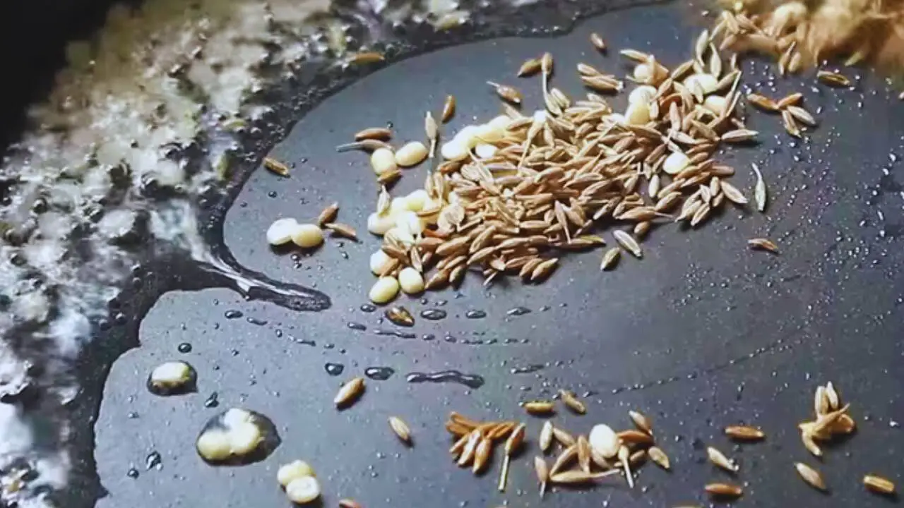 Added 1 tsp of black gram split (urad dal) and 1 tsp of cumin seeds to the frying pan