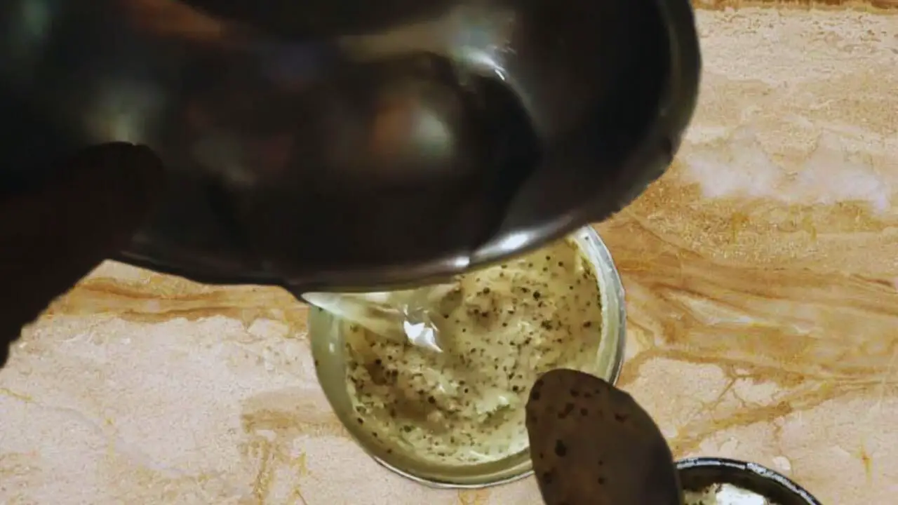 Adding a little bit more water to the paste in the grinder