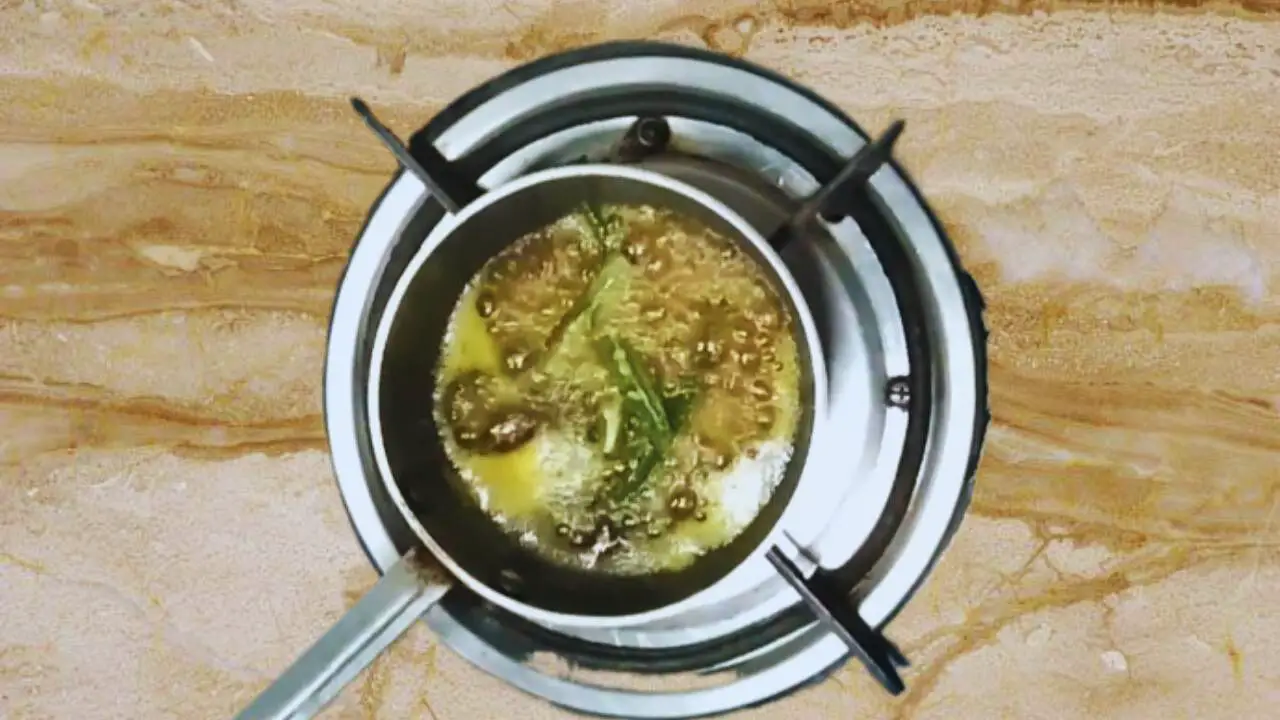 Adding fresh green chilies in tadka pan
