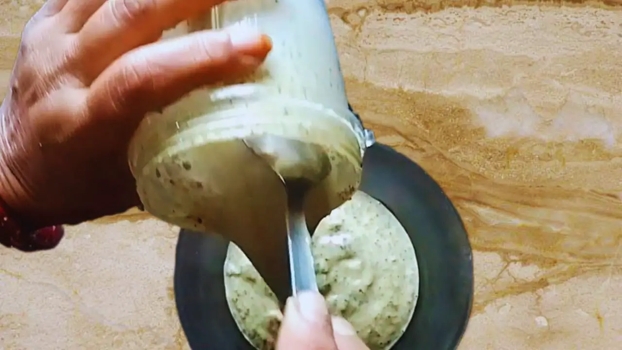 Washing the grinder with a little bit of water and add it to the paste in the bowl