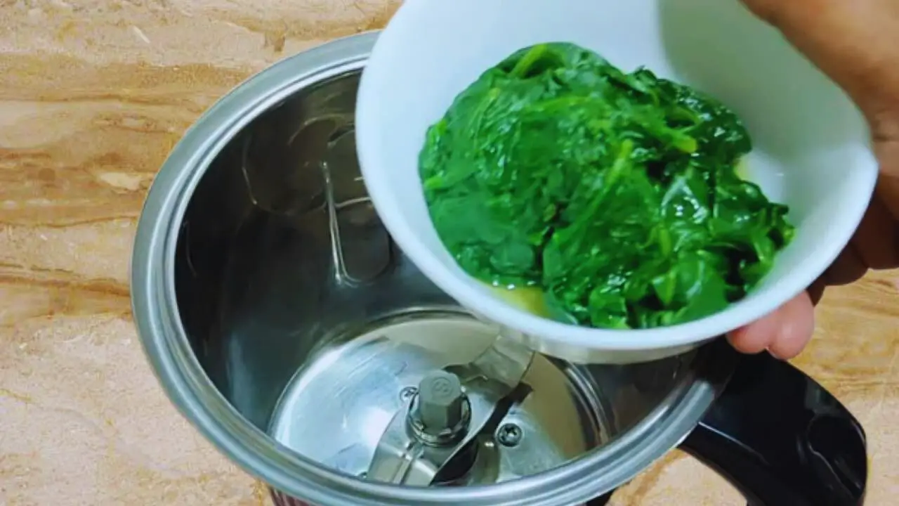 Put the blanched and washed spinach leaves in grinder
