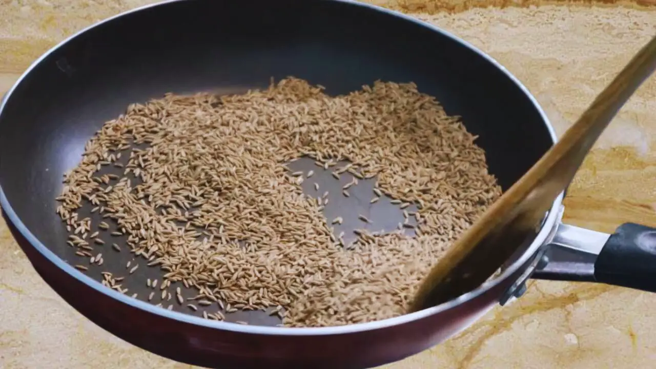 Stirring the cumin seeds