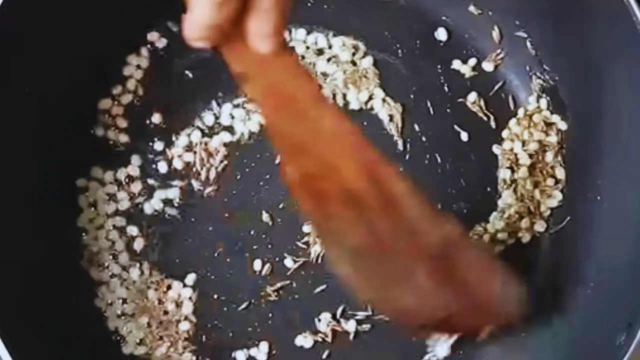 Stirring the spices continuously