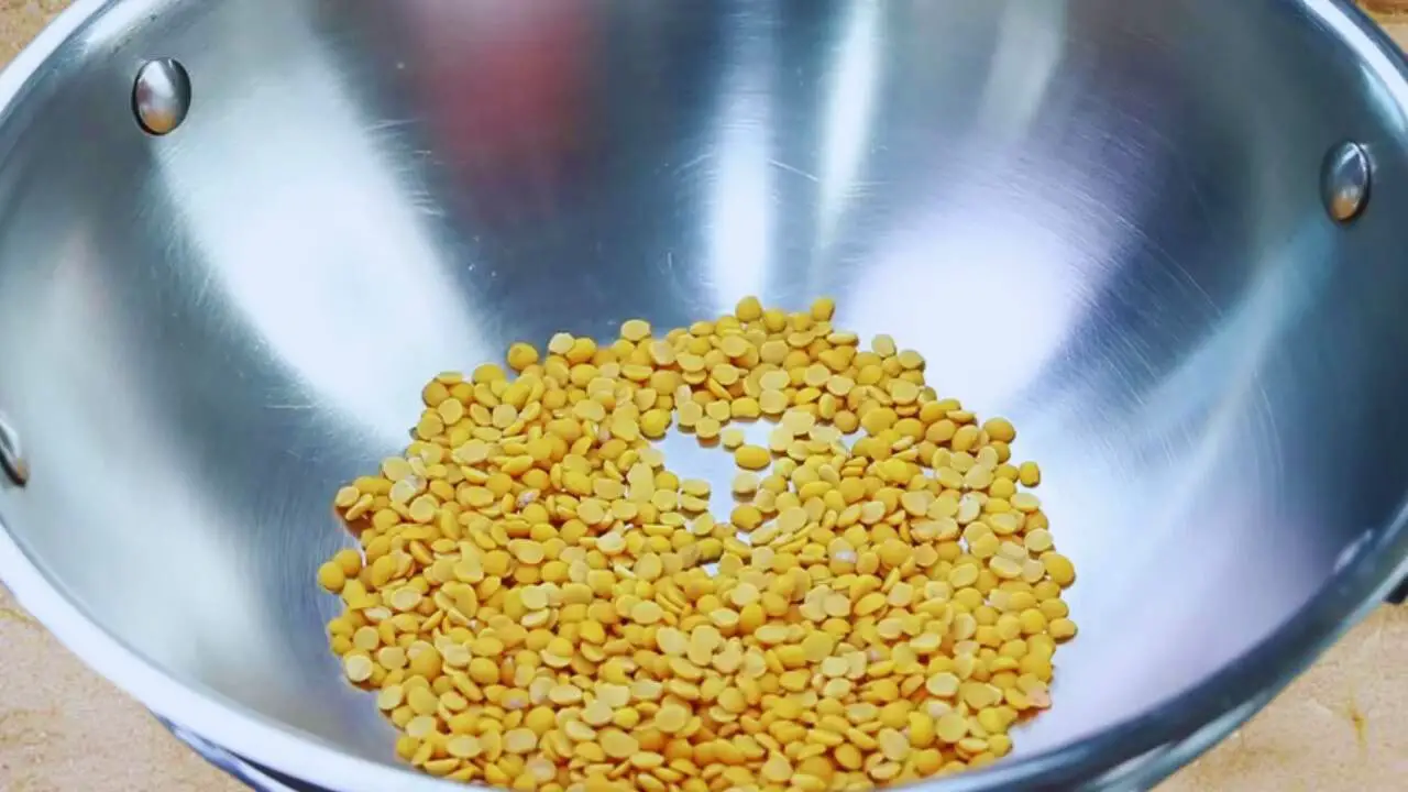Putting 4 tbsp of split pigeon peas (toor dal) in