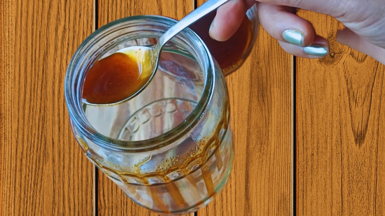 Greasing a sun-dried glass jar with the reserved mustard oil