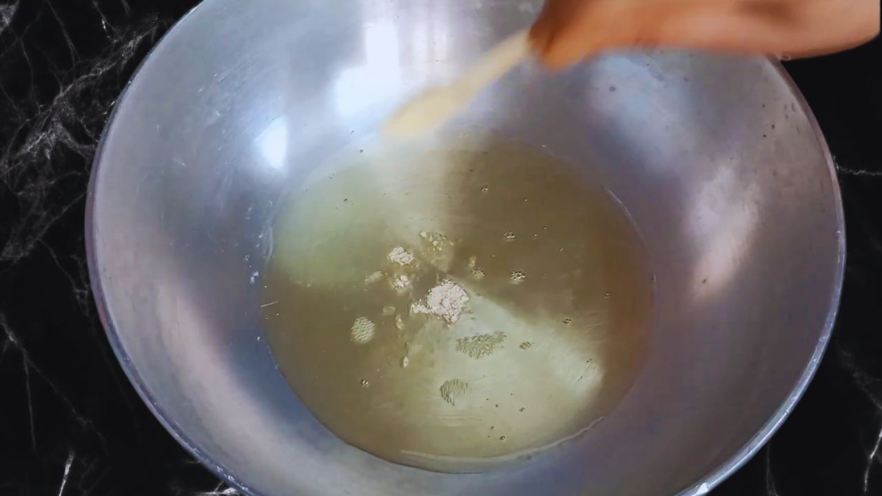 Adding a pinch of asafoetida to the heated oil