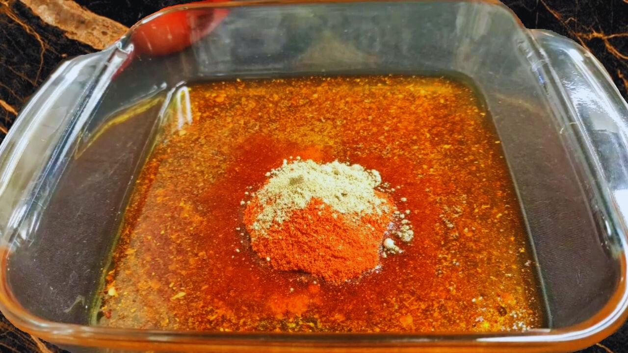 1/3rd cup mustard oil, then the home-made spice mix, 1 tbsp mustard powder, ½ tsp turmeric powder, 2 tsp red chili powder and ½ tsp asafoetida powder in a mixing bowl