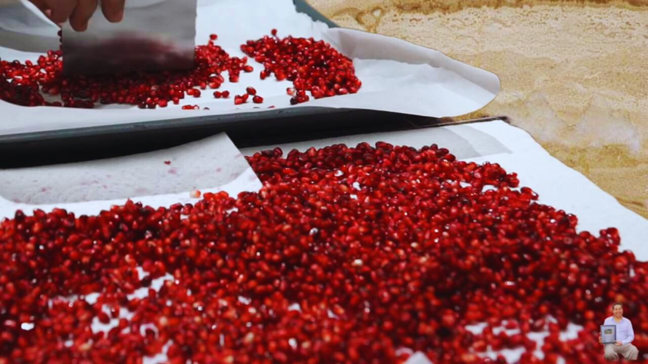 Putting the pomegranate seeds on the tray