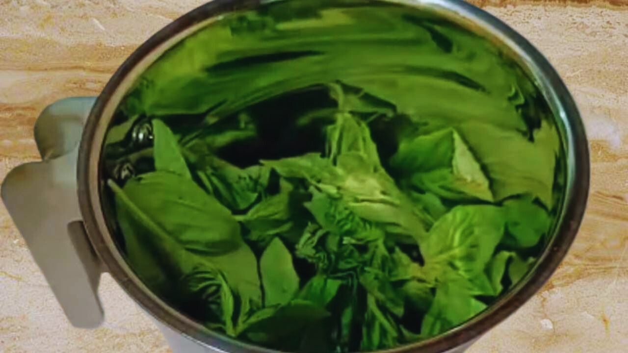 1 cup of fresh basil leaves in grinder