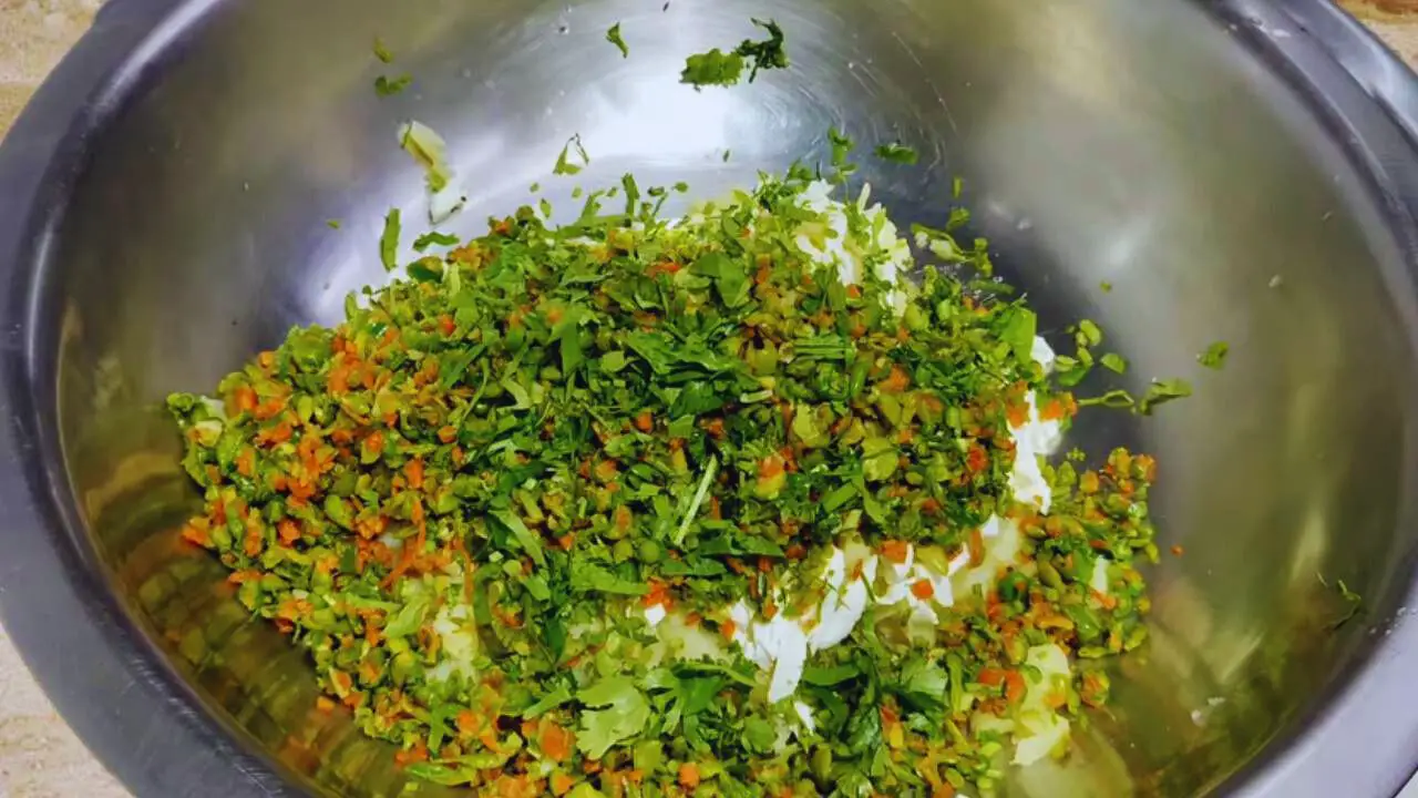 Adding coriander leaves to make vegetable kabab 