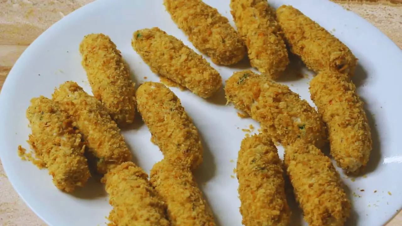 Chicken fingers coated in egg yolk and bread crumbs