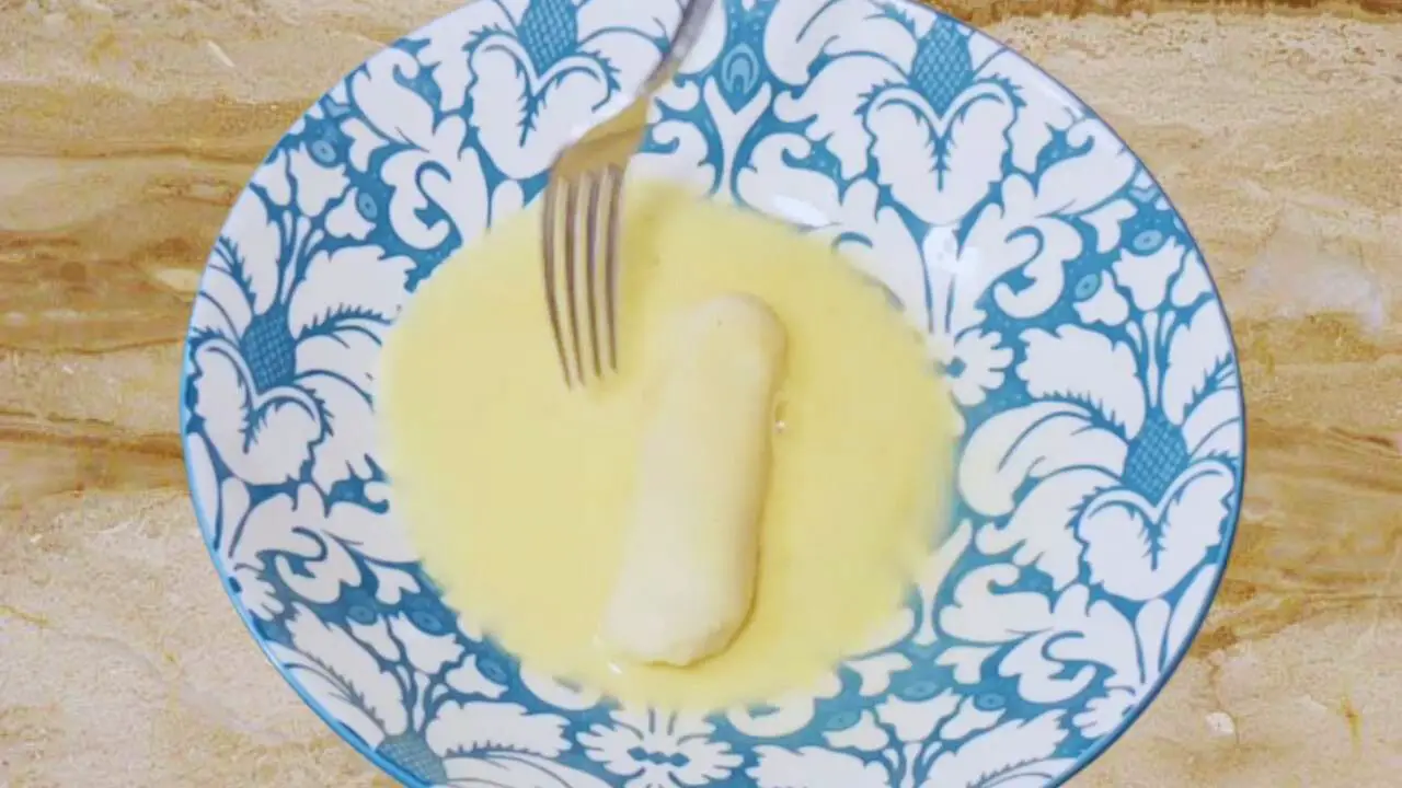Coating cheese stick with egg wash