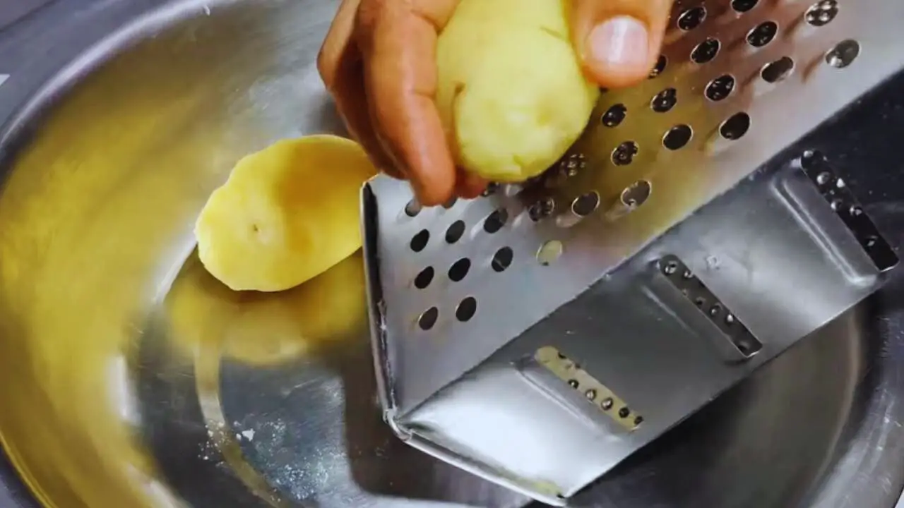 Grating boiled potatoes to add to vegetable kabab 