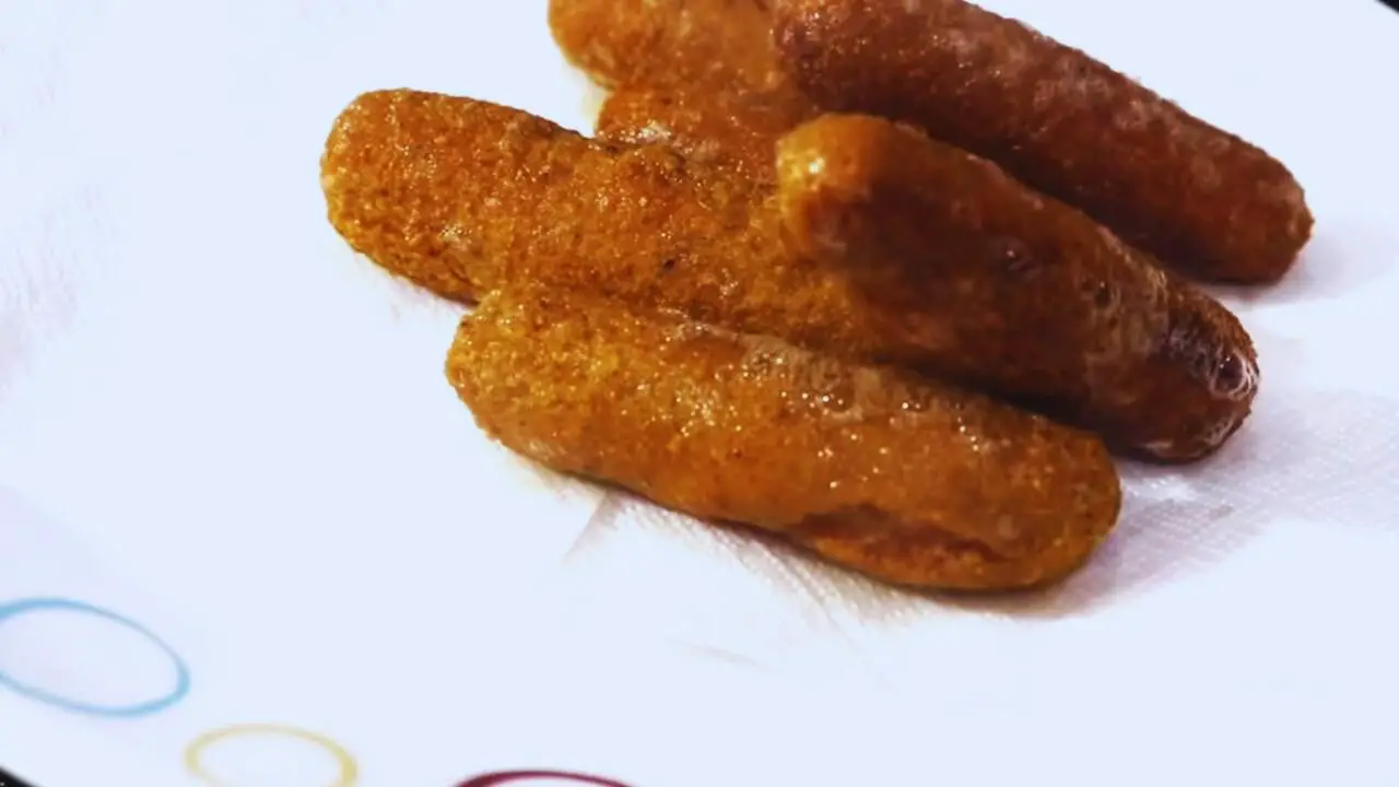 Laying fried chicken fingers on tissue paper