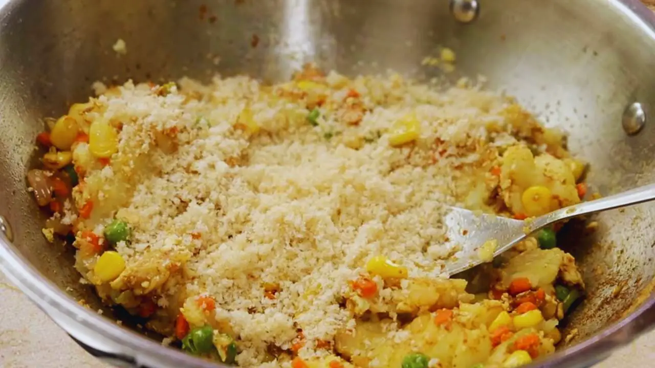 Adding bread crumbs to the vegetable finger mixture 