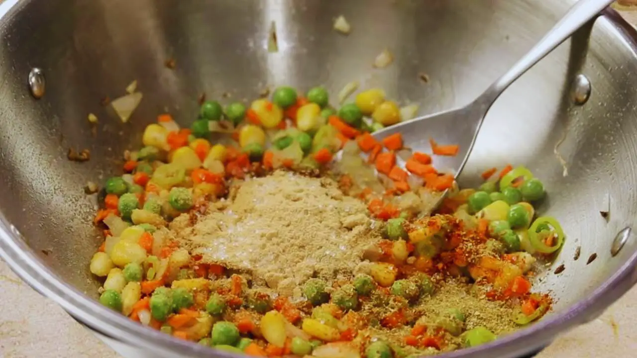 Adding dry spices to the vegetable finger mixture 