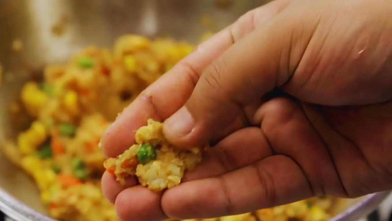 Checking the texture of the vegetable finger mixture 
