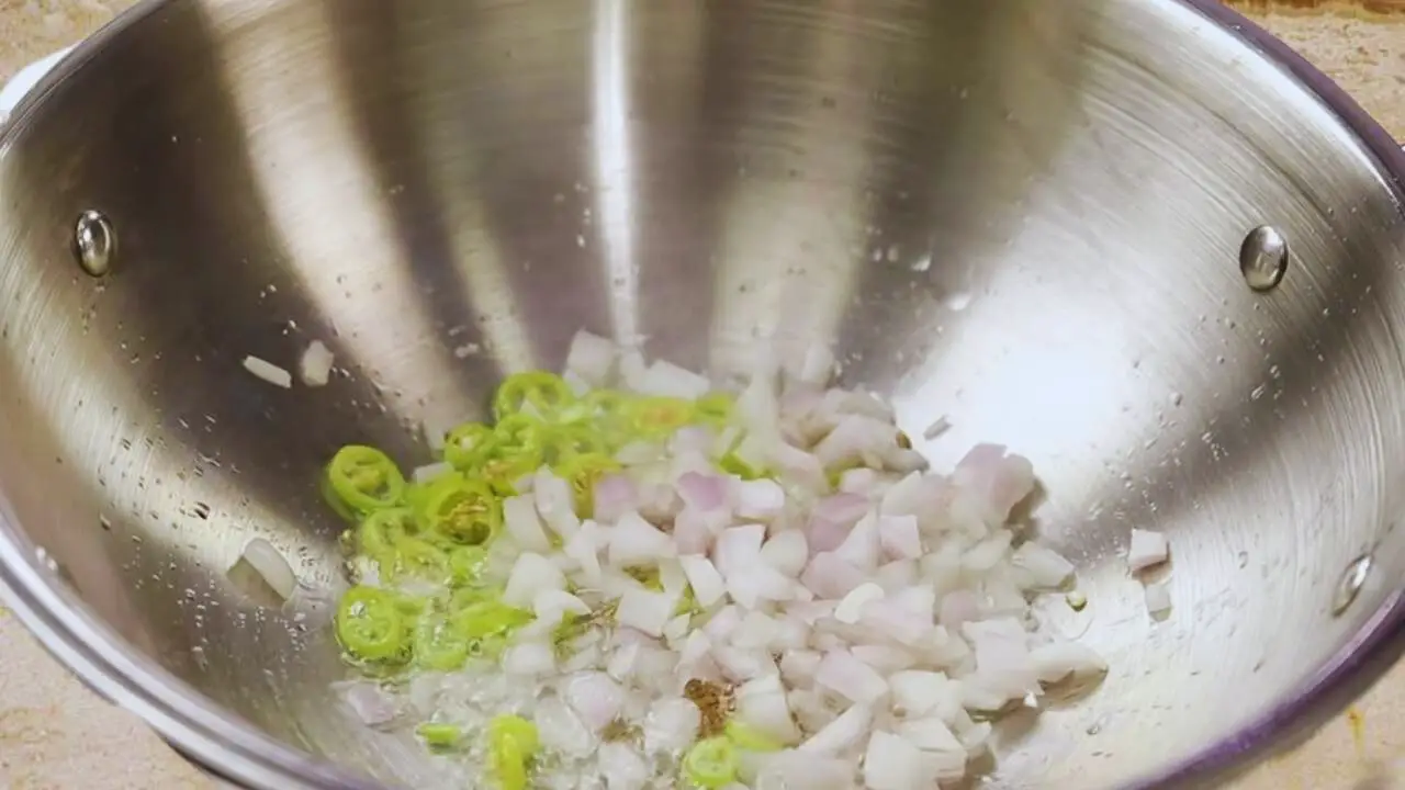 Cooking chiles and onions for the vegetable finger mixture 