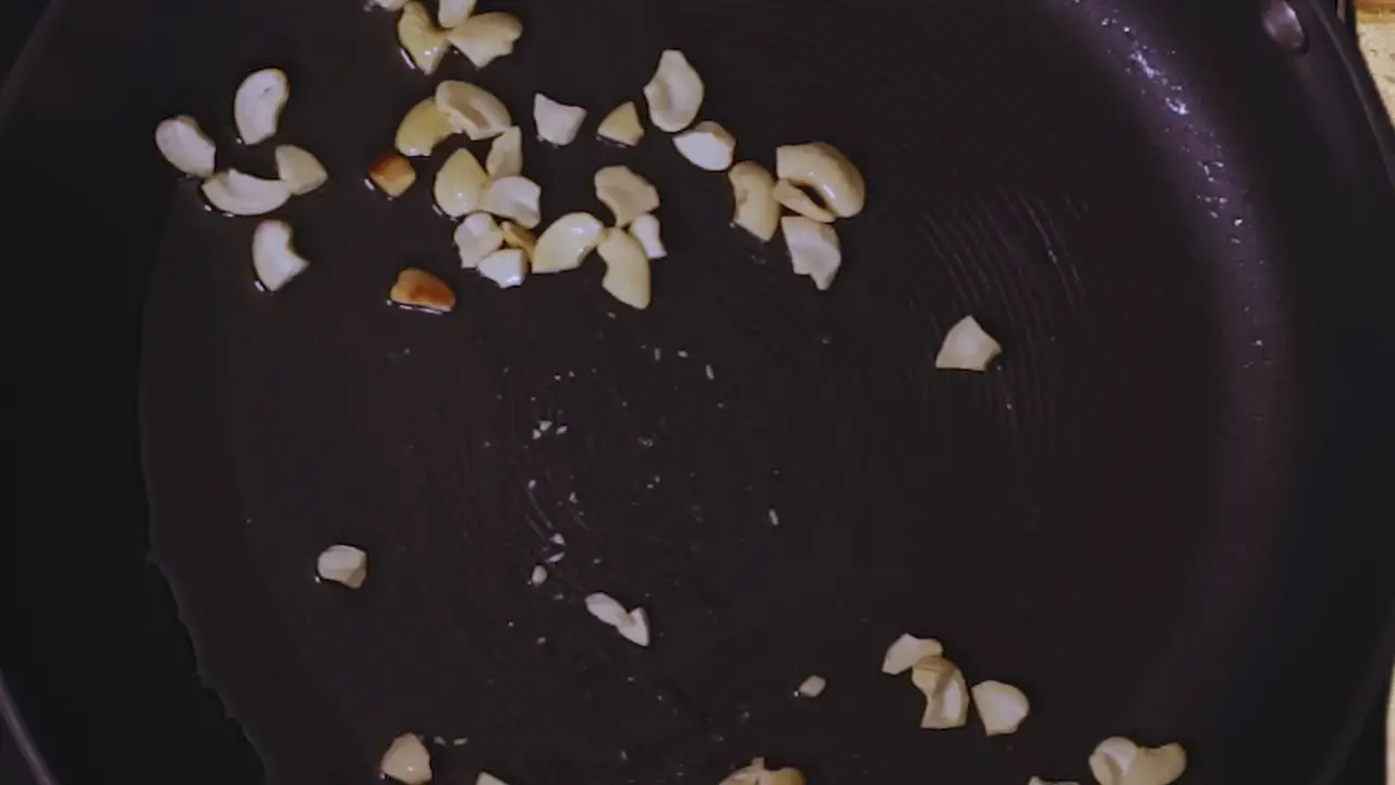 Frying cashew nuts in cooking oil to add in beetroot cutlet mixture 
