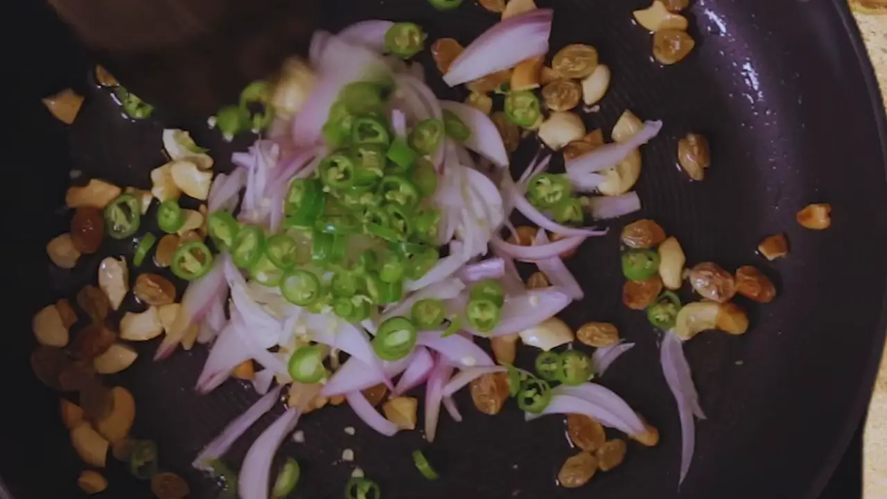 Adding onions and green chilies for the beetroot cutlet mixture 