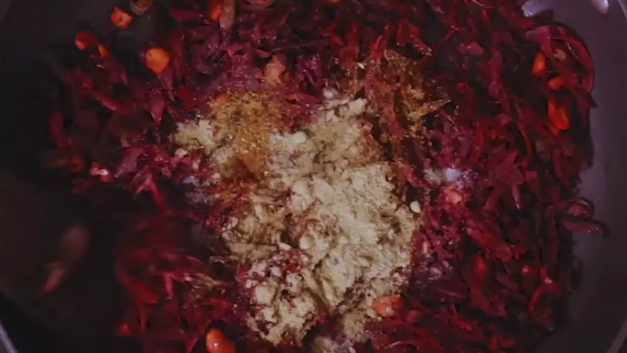 Adding salt and spice powder to the beetroot cutlet mixture 
