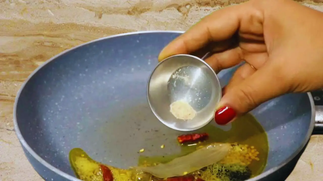 Adding all spices to make tomato chutney