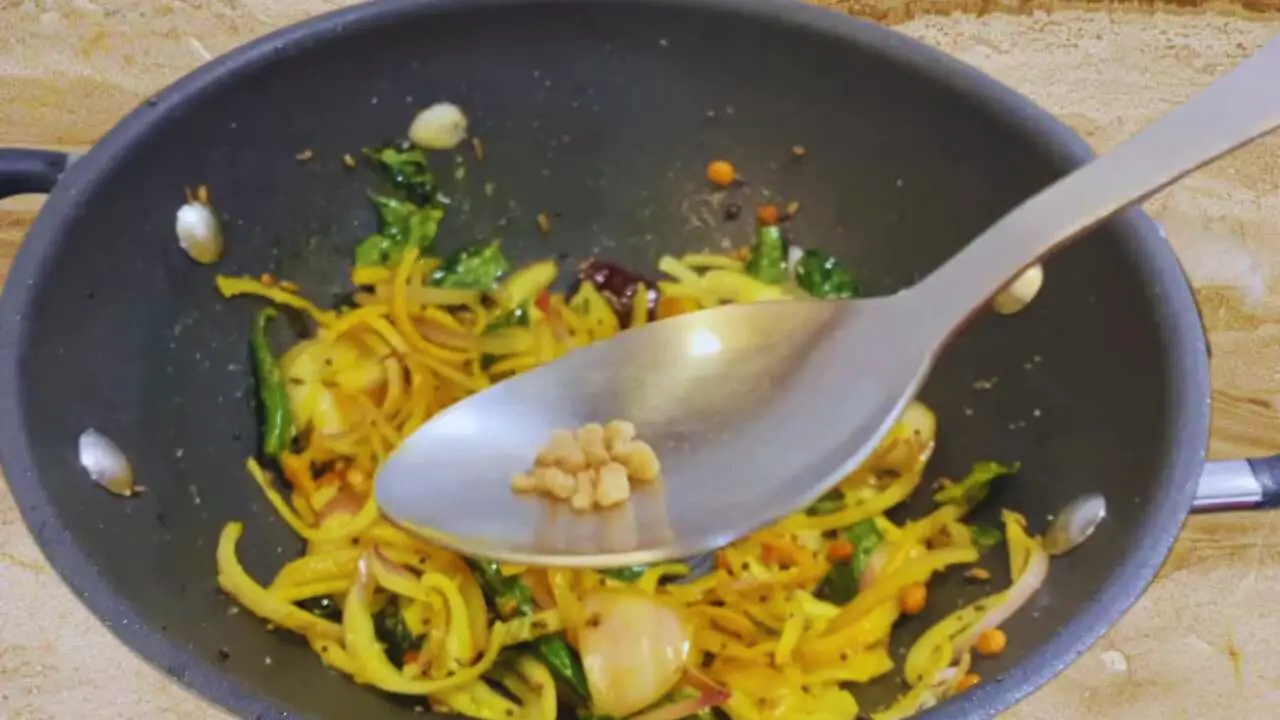 Adding asafetida to Bombay Chutney ingredients 