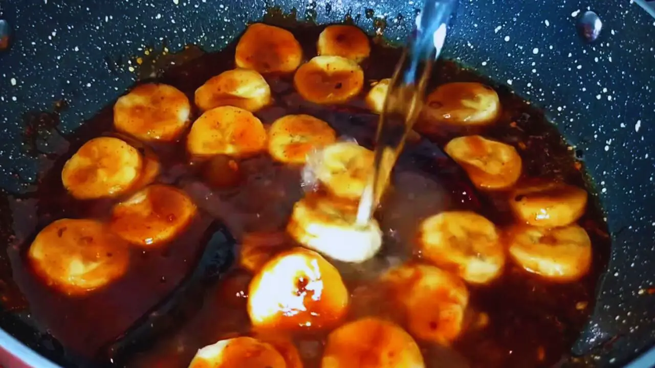 Adding bananas and water to make the chutney 