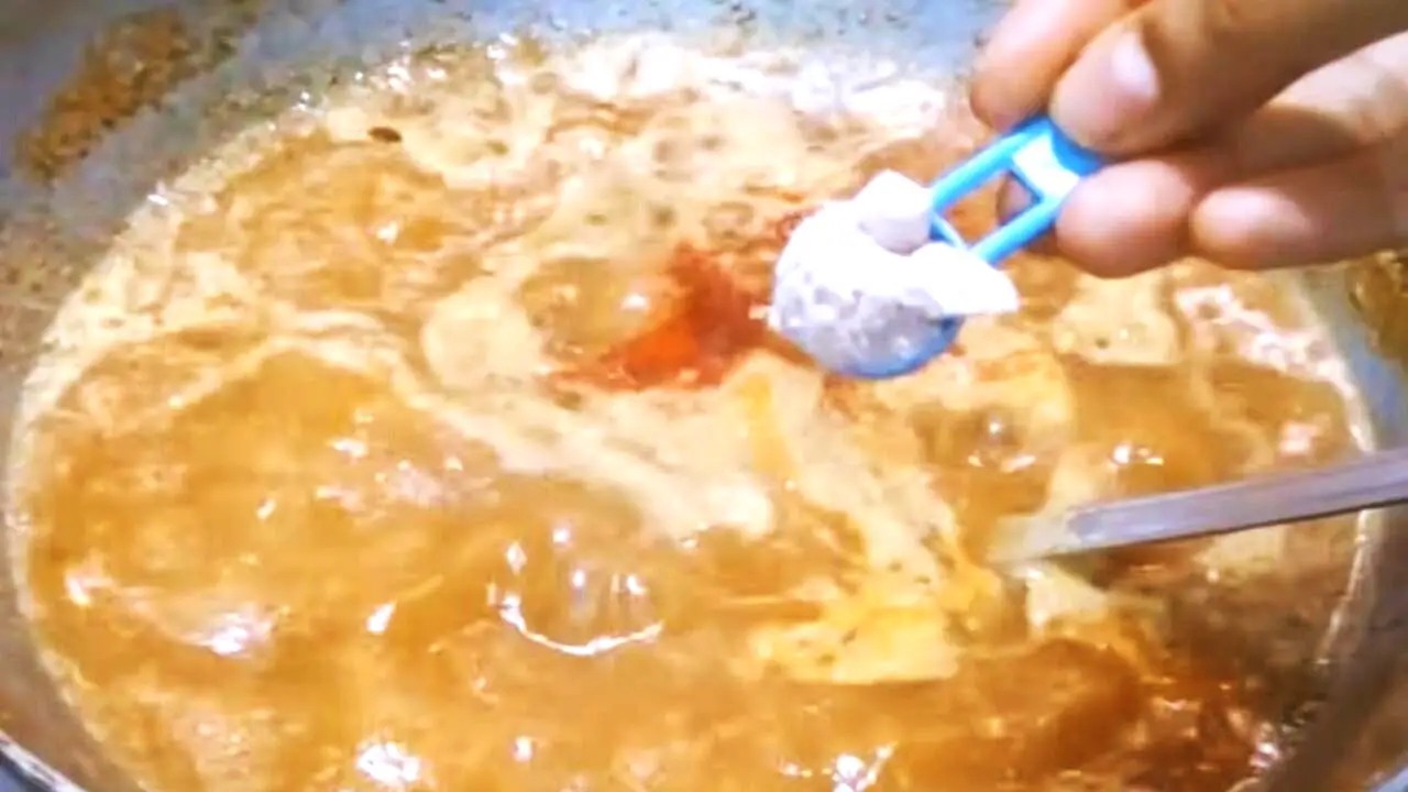 Adding black salt to tamarind chutney