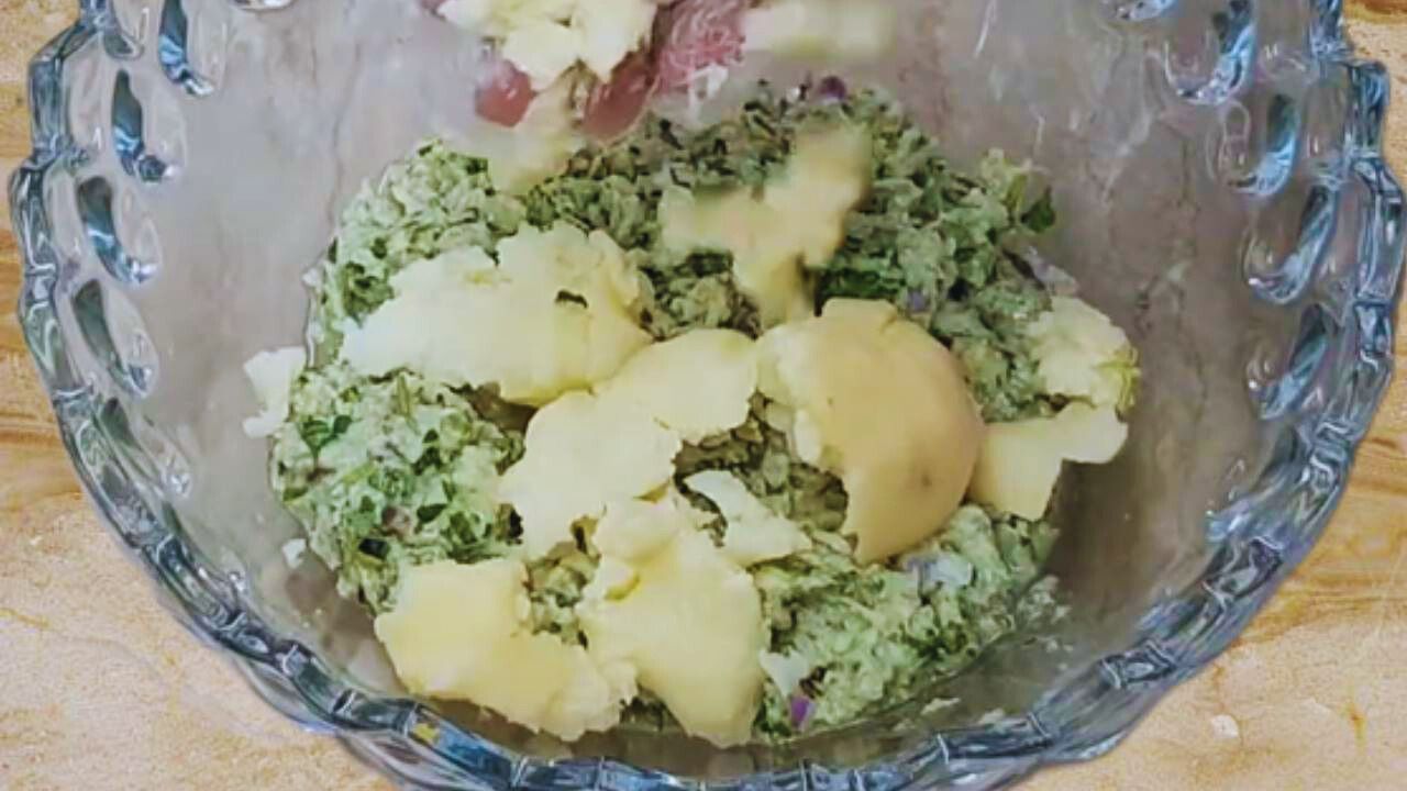 Adding boiled potato to prawn kabab mixture 