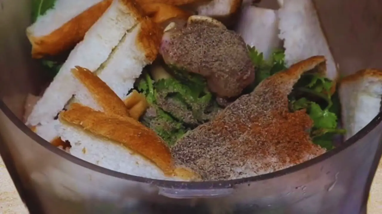 Adding bread and powder masala to Chicken Cutlet ingredients 
