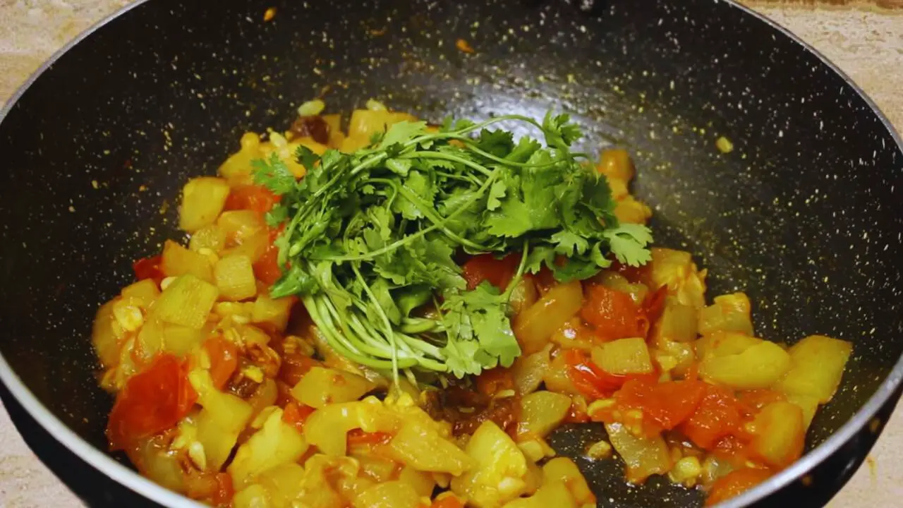 Adding coriander leaves to Bottle Gourd Chutney ingredients 