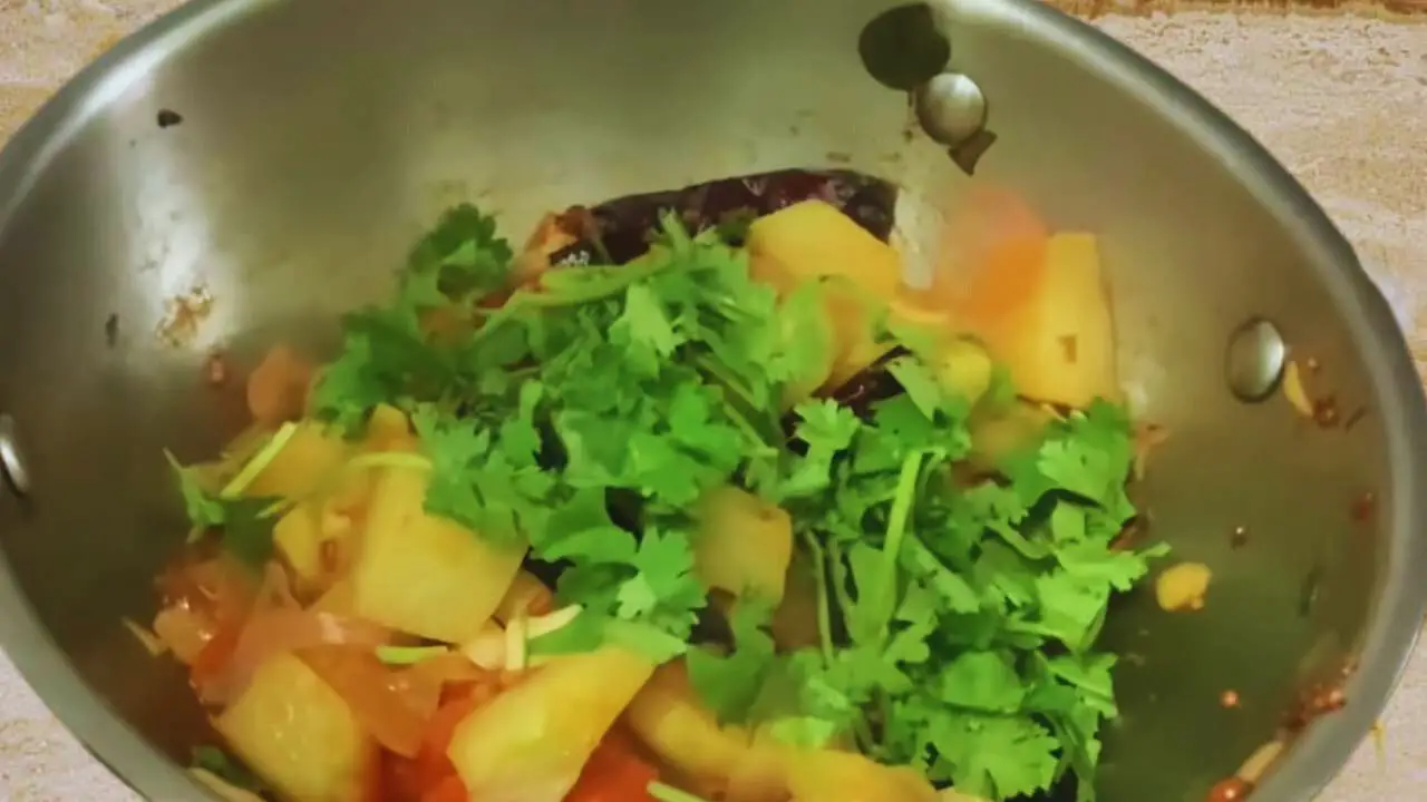 Adding coriander leaves to Chow Chow Chutney ingredients 