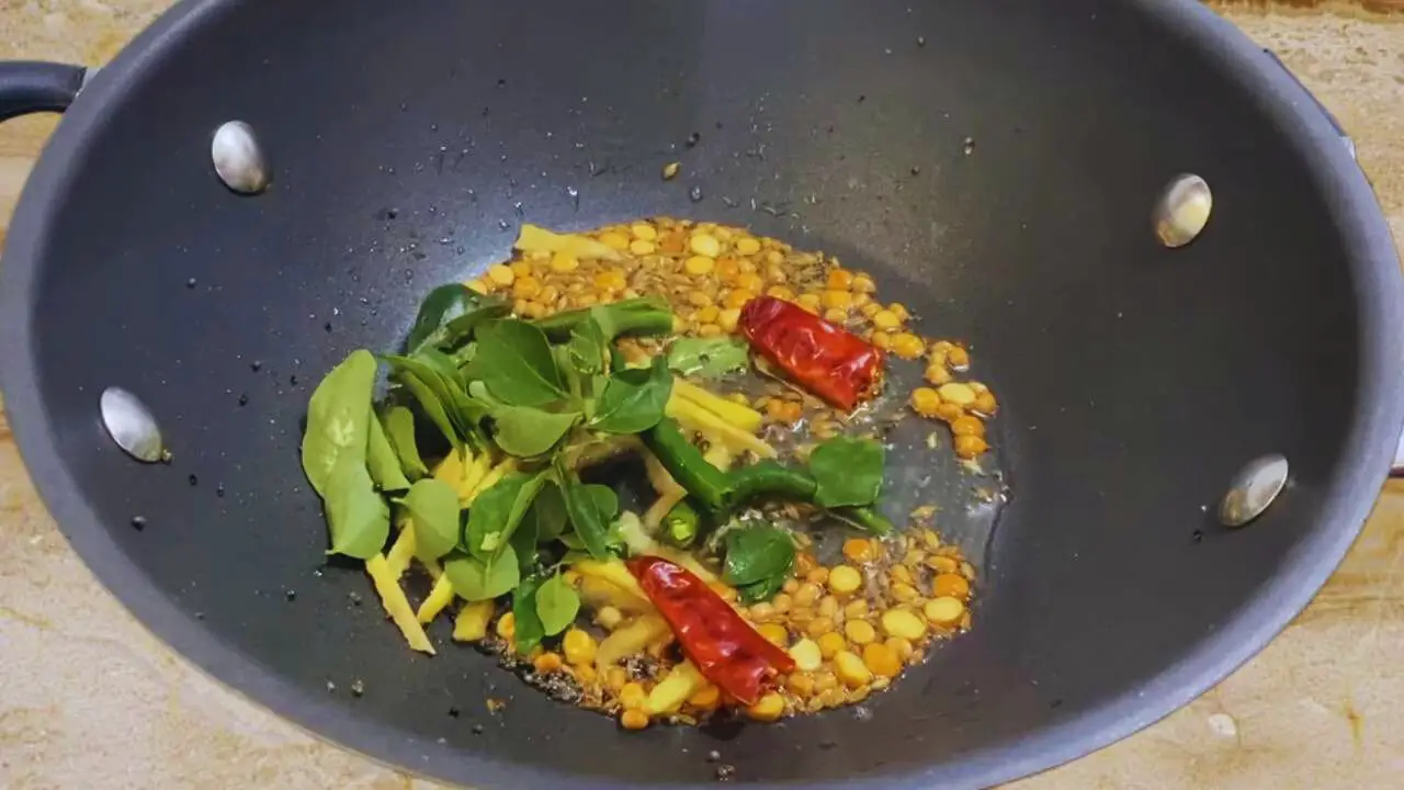 Adding curry leaves to Bombay Chutney ingredients 
