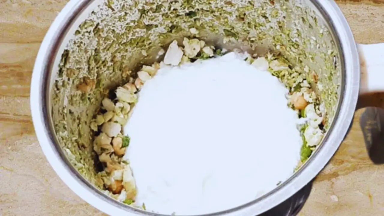Adding dahi to the ingredients 
