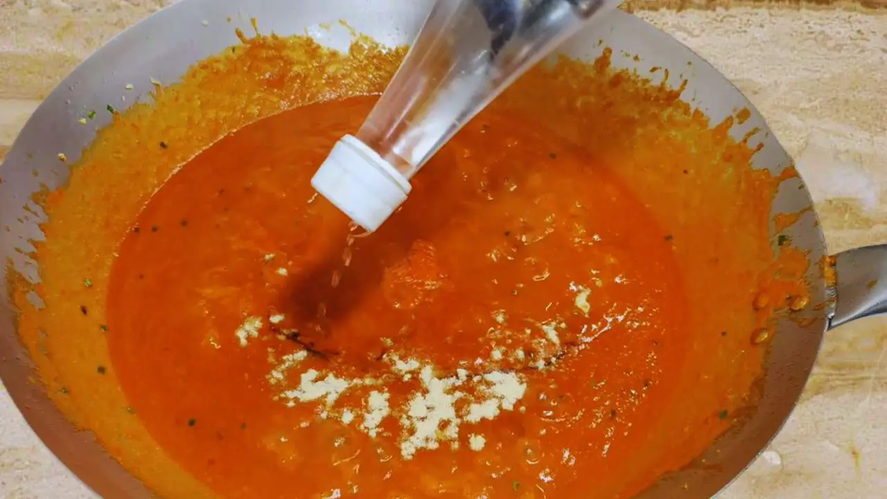 Adding different sauces and vinegar to Momos Chutney 