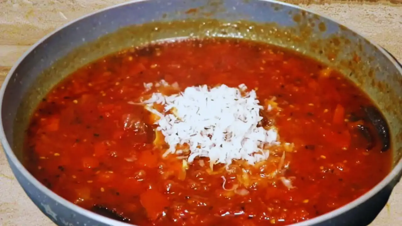 Adding dry fruits to tomato chutney