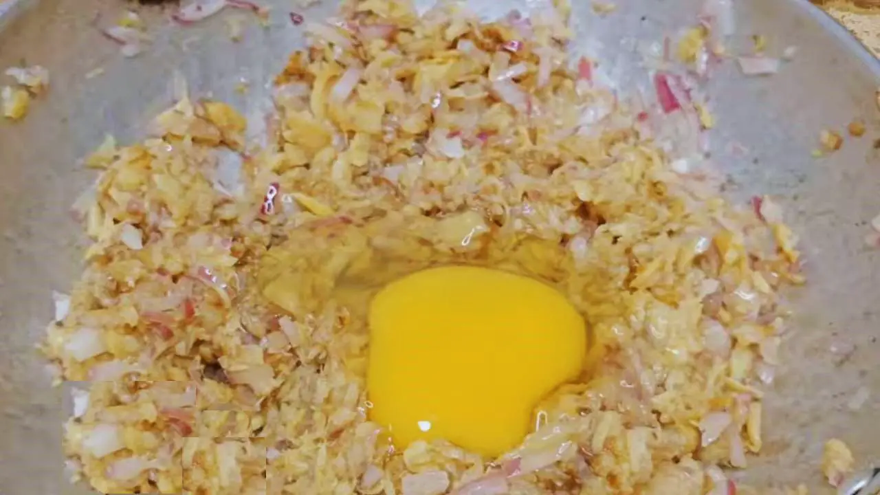 Adding egg to Fish Momo ingredients 