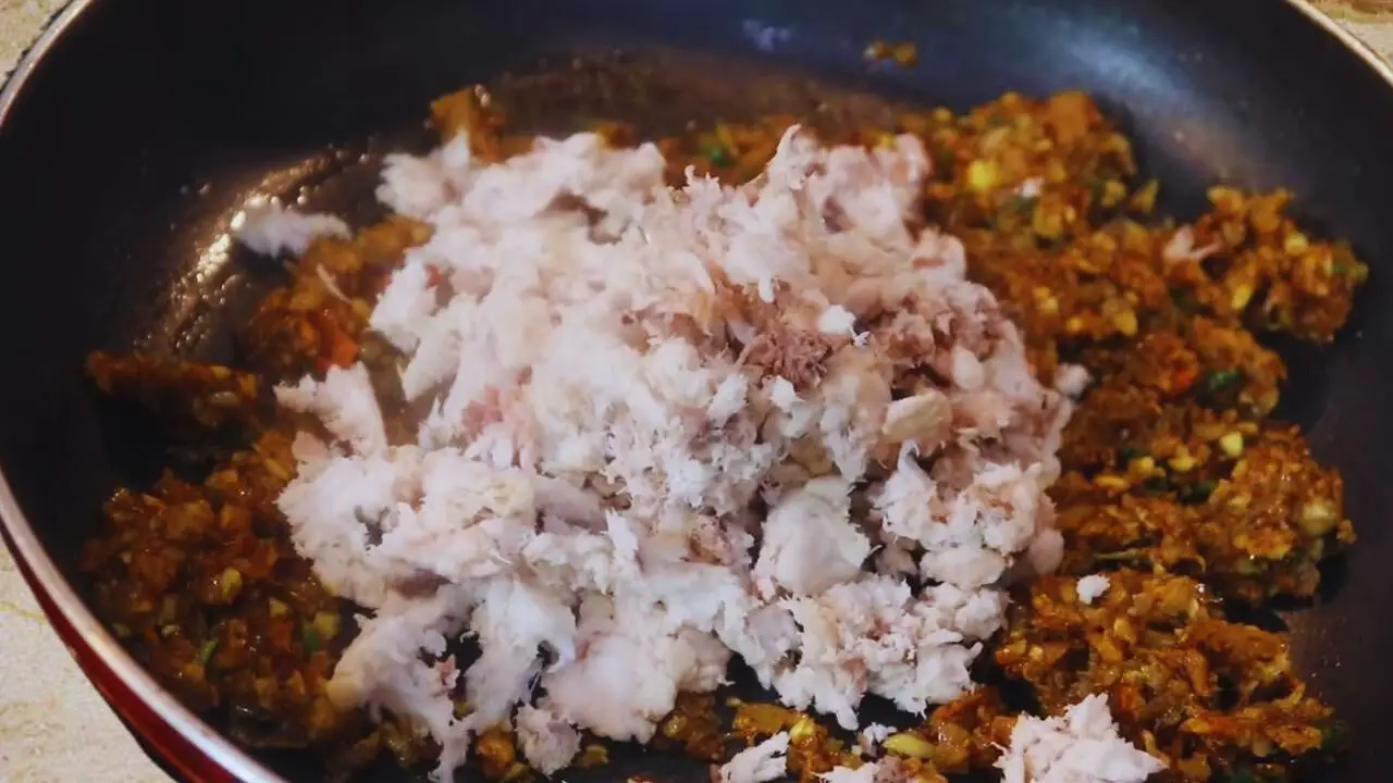 Adding fish to the ingredients 