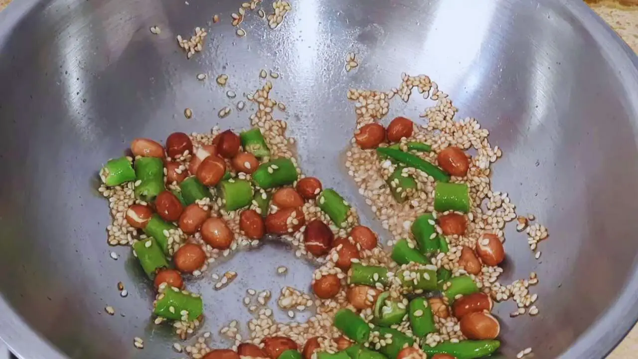 Adding green chilies to Green Tomato Chutney ingredients 