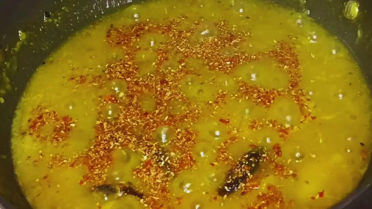 Adding ground roasted spices to Jalpai Chutney 