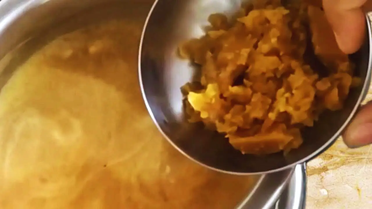 Adding jaggery to Date Chutney 